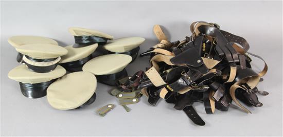 Eight beige military hats / caps together with a collection of military leather gun holsters, belts, etc.